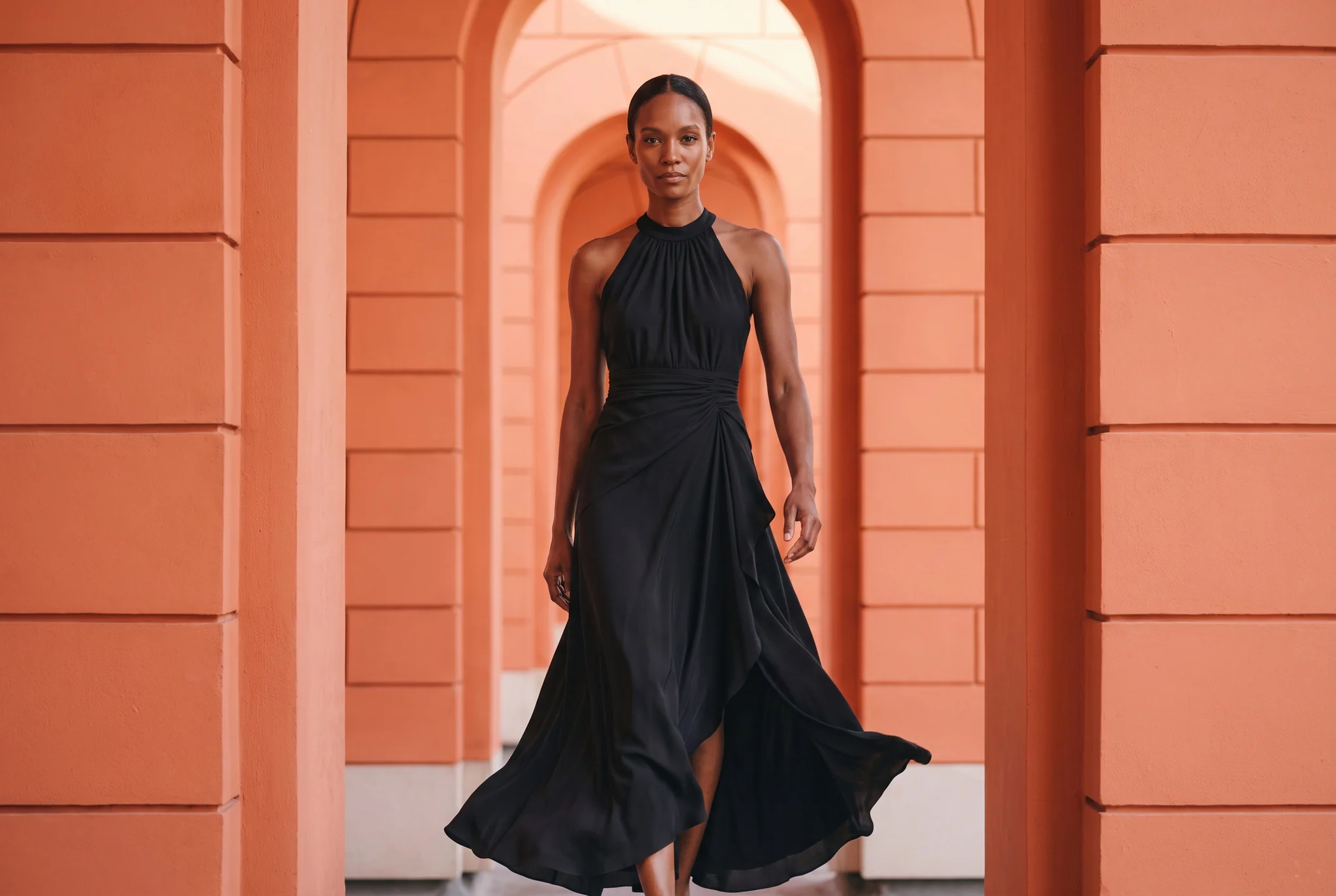 Black halter maxi dress among coral arches
